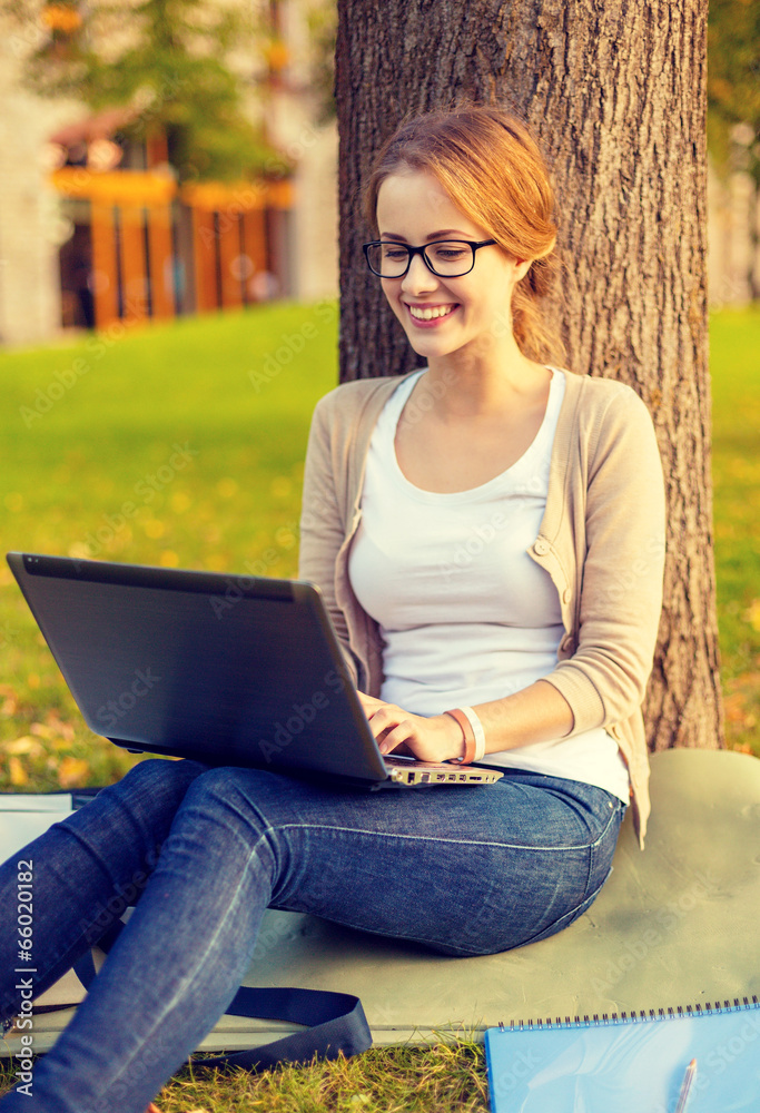 smiling teenager in eyeglasses with laptop smiling teenager in eyeglasses with laptop