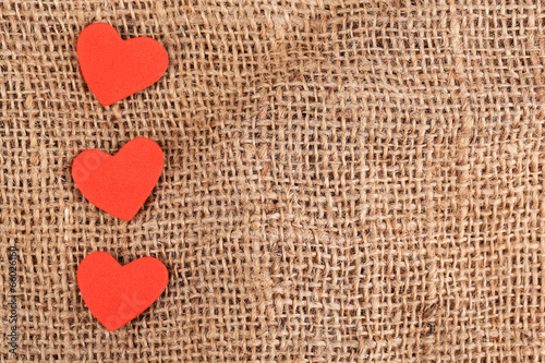 Hearts made of felt on sacking background