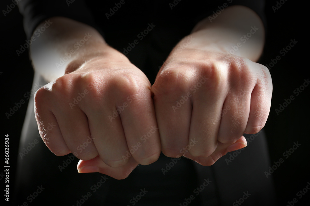 Hand fists on black background