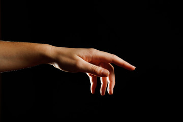 Human hand on black background