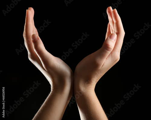 Human hands on black background