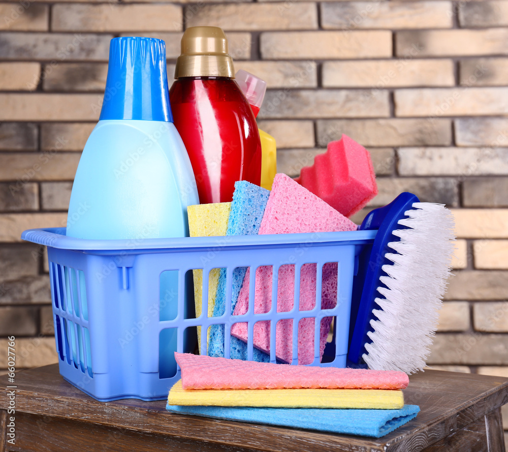 Cleaning products on shelf on bricks wall background