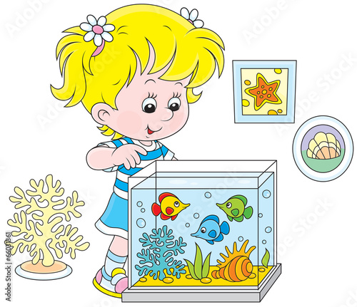 Little girl watching fishes in an aquarium