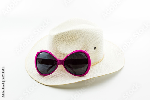 White woven hat with pink sunglasses.