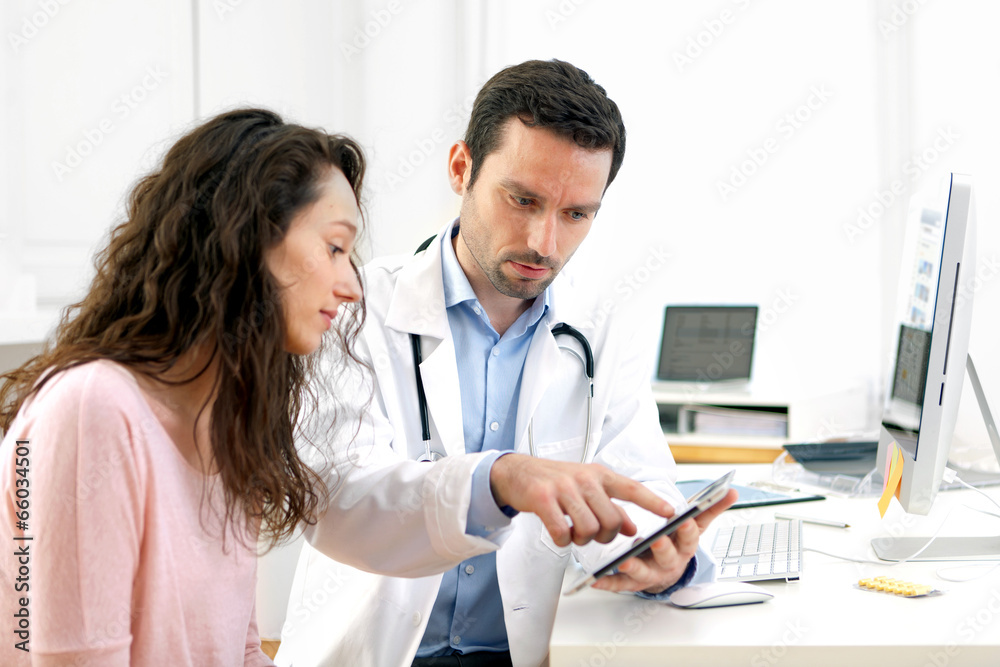 Doctor using tablet to inform patient