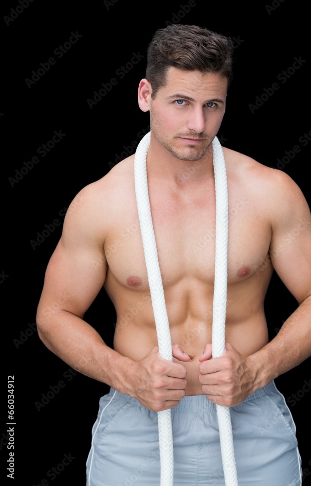 Strong crossfitter posing with rope around neck Strong crossfitter posing with rope around neck