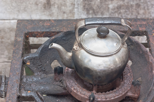 Old kettle on rusty gas stove
