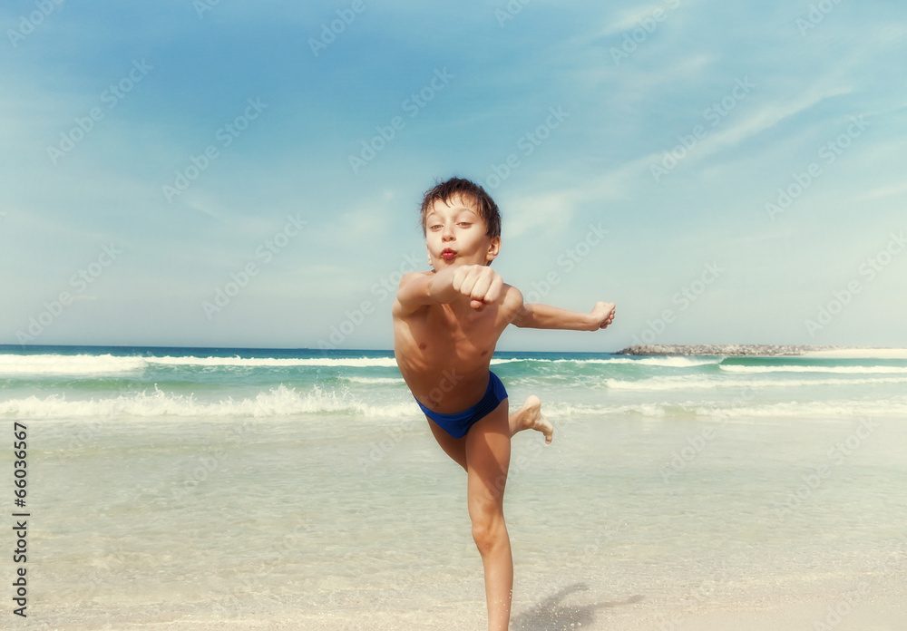 Beautiful child running on the beach with funny expression Beautiful child running on the beach with funny expression