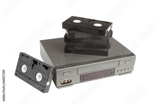 stack of videotapes on videorecorder isolated on white photo
