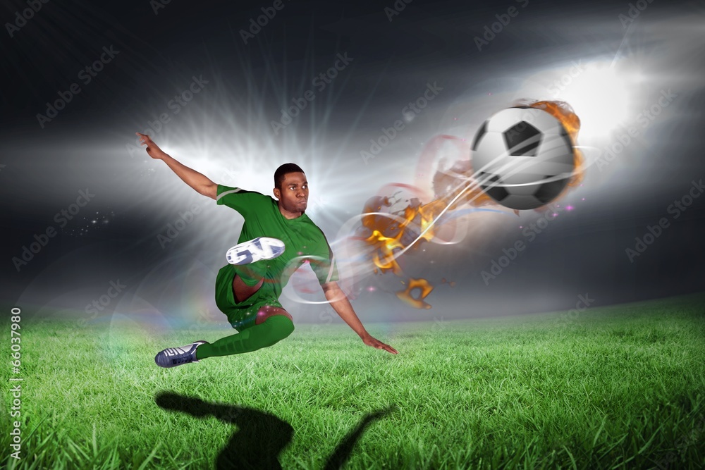 Naklejka premium Composite image of football player in green kicking