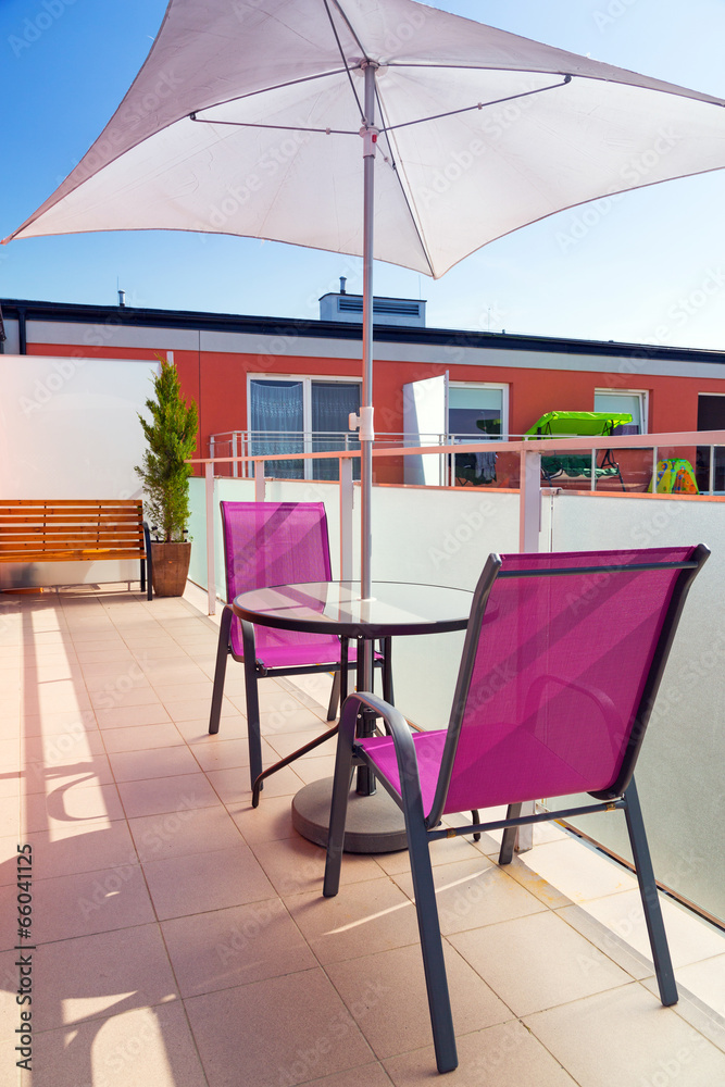 Fototapeta premium Table with sun parasol on the apartment balcony
