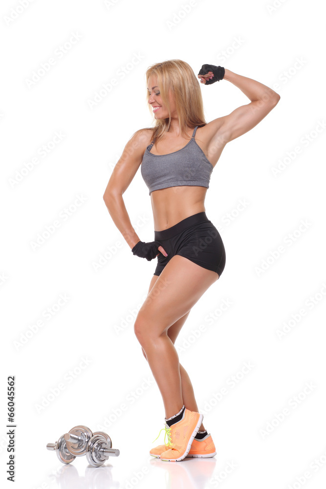 beautiful fitness female posing on studio background