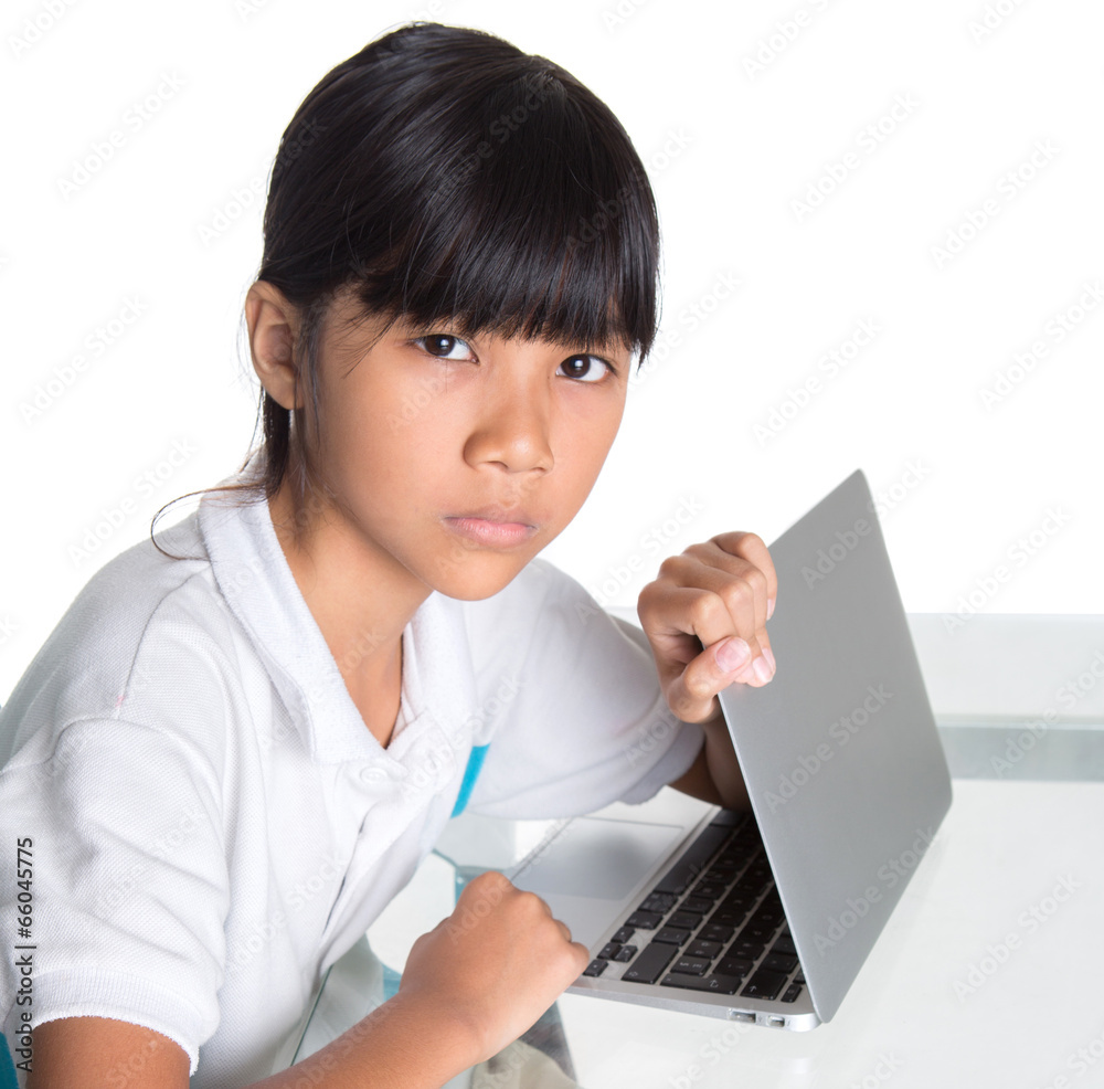 Young Asian school girl protecting hiding her computer screen Young Asian school girl protecting hiding her computer screen