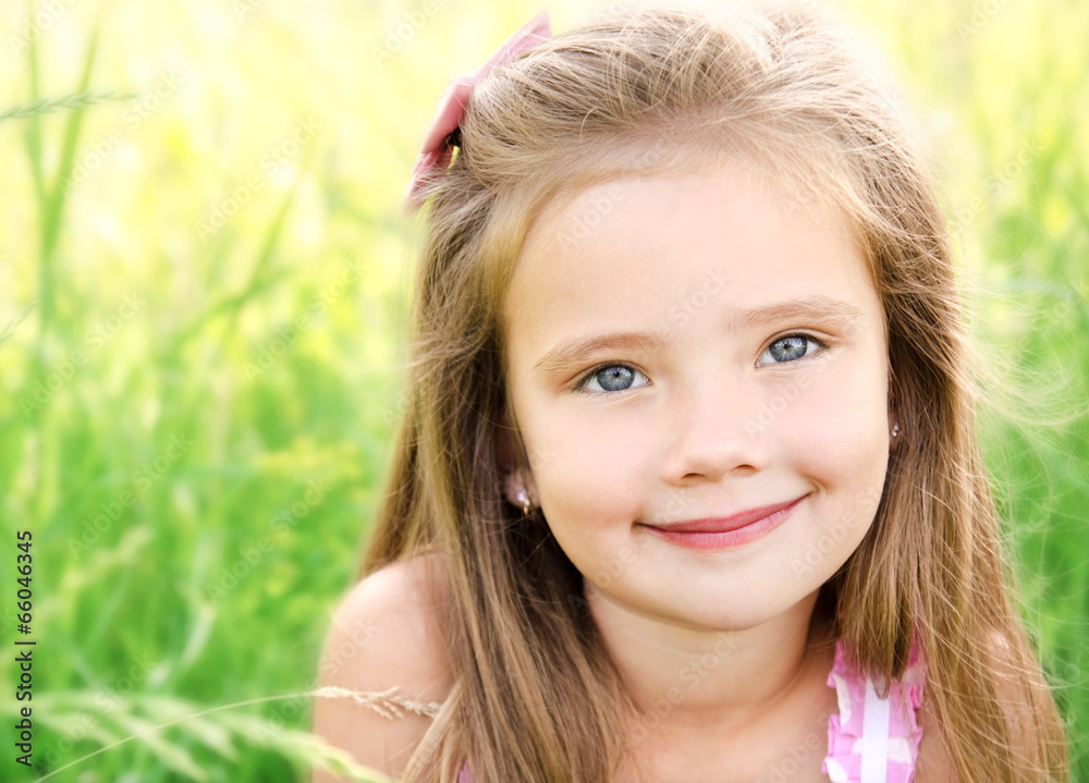 Fototapeta premium Portrait of adorable smiling little girl