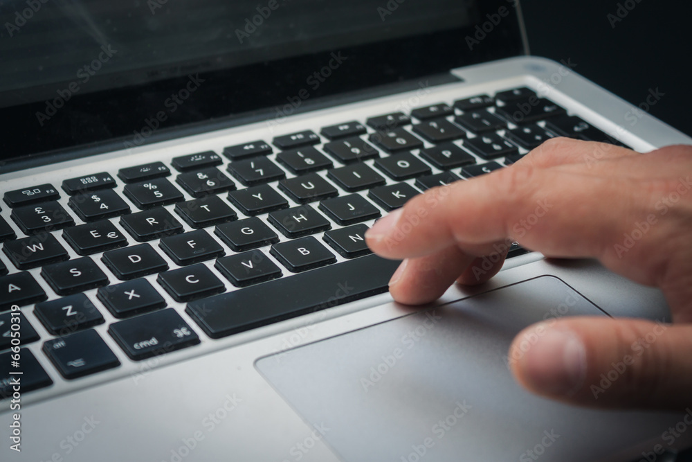 Detail of hands working on computer keyboard Detail of hands working on computer keyboard