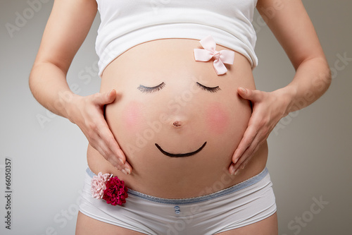 Pregnant belly look like a smiling face photo