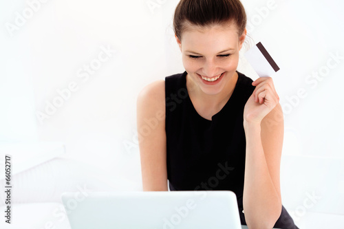 Happy Woman Holding a Credit Card and Shopping From the Internet