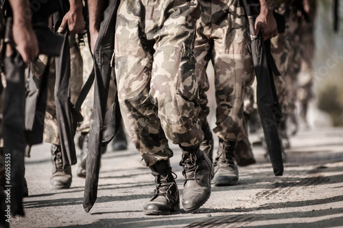 running soldiers carrying weapons