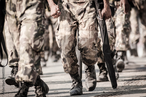running soldiers carrying weapons