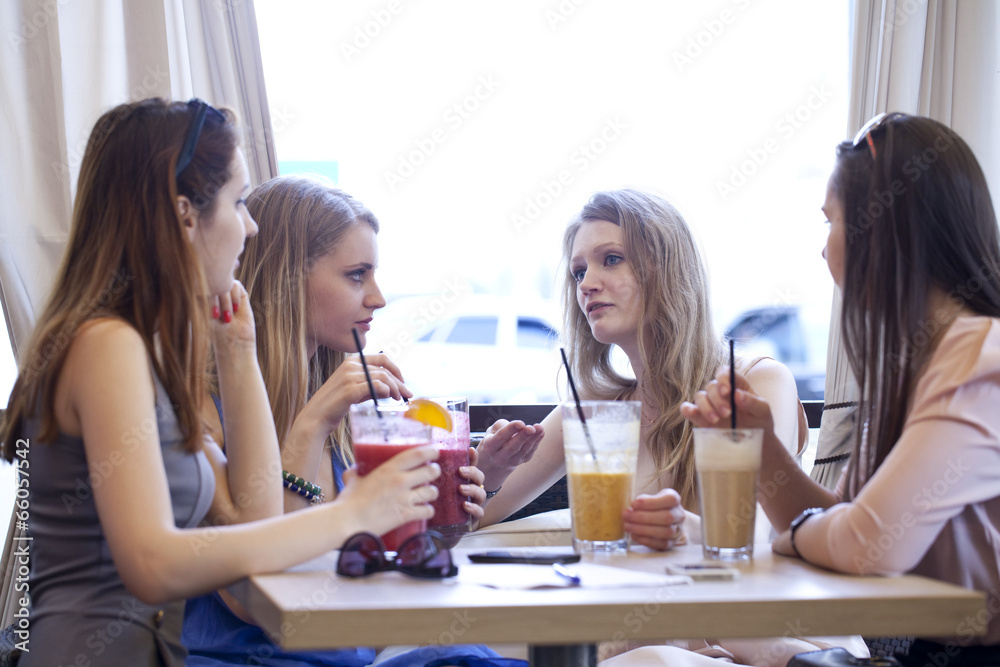 Four young girls have a rest in a summer cafe Four young girls have a rest in a summer cafe