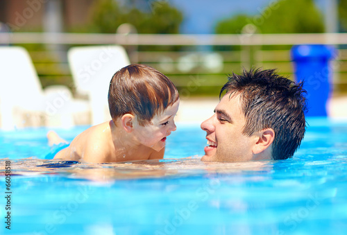 happy family in summer pool © Olesia Bilkei