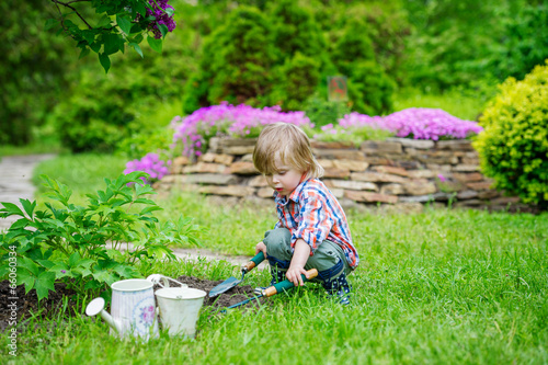 Cute kid playing in the beautiful garden