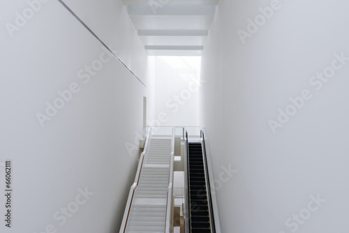 large hallway with escalator and stairs