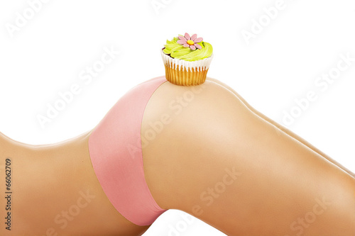 closeup on a girl showing a cupcake on her body