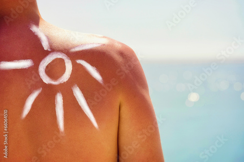 Close up of a man`s shoulder and suncream on it.