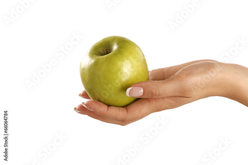 Green apple in a female beautiful hand