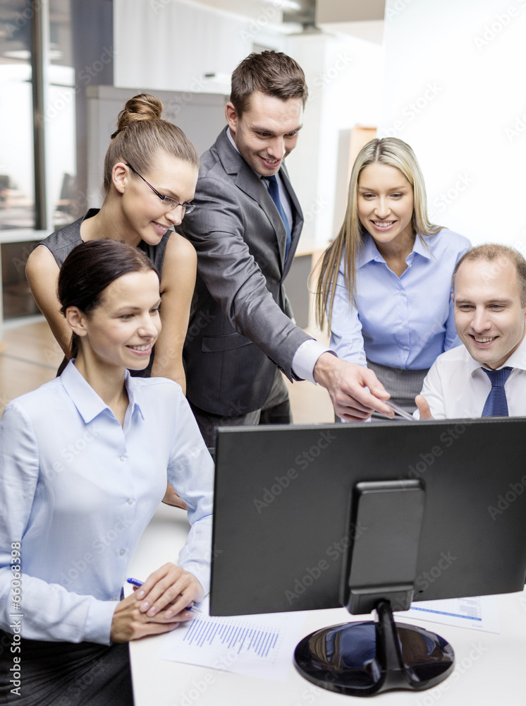 business team with monitor having discussion