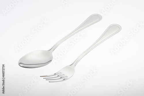 a silver fork with spoon isolated on gray background