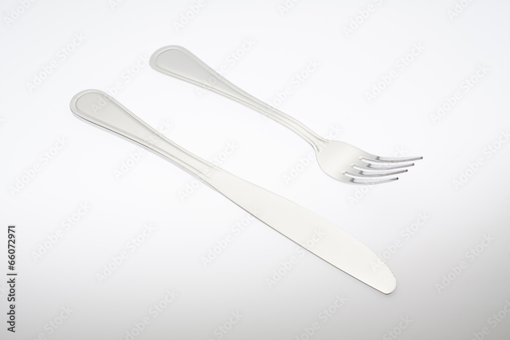 a silver fork with knife isolated on white background a silver fork with knife isolated on white background