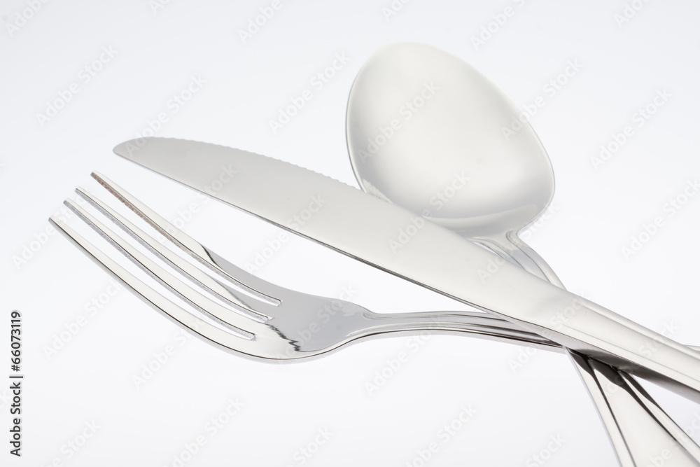 a silver fork with spoon knife isolated on white background a silver fork with spoon knife isolated on white background