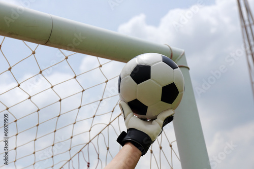 reaching for the foot ball