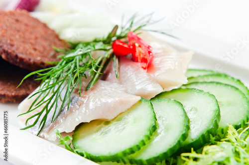 Fillet of a herring with cucumbers