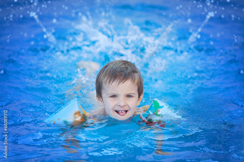 Cute kid in a big swimming pool