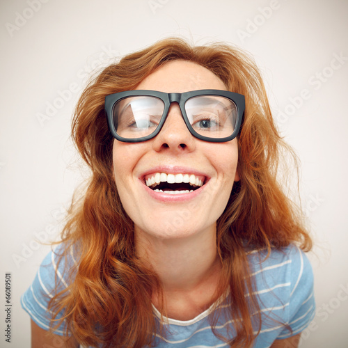 Portrait of happy funny young woman with black glasses.