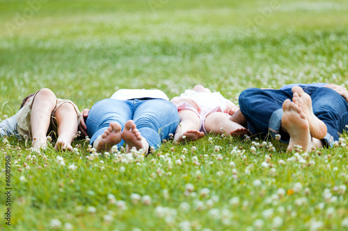 Happy young Family lying on grass