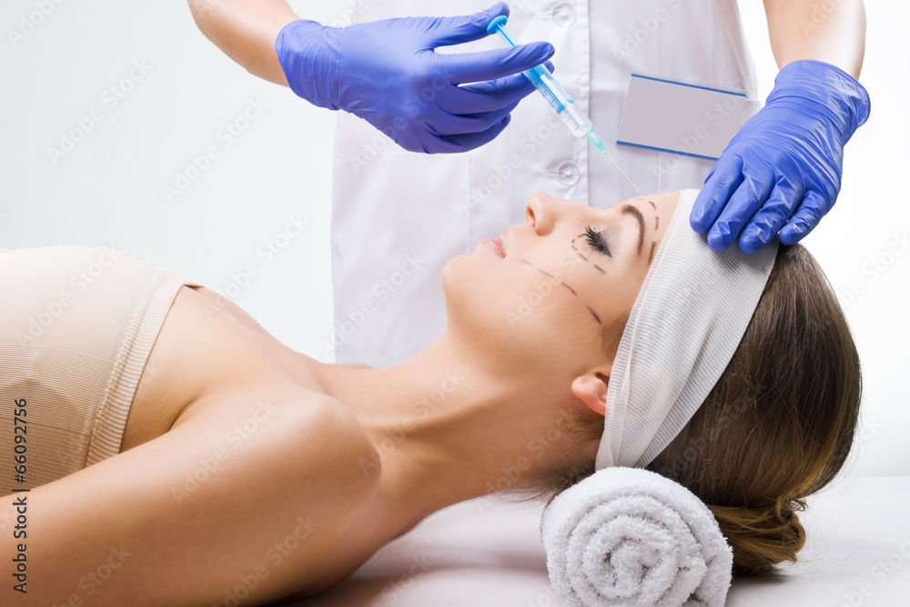 Naklejka premium Beautiful woman lying in the clinic,
