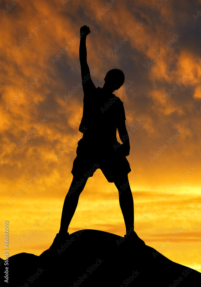 Silhouette of tourist on the top in the sunset.