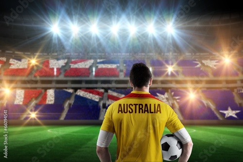 Composite image of australia football player holding ball © WavebreakmediaMicro