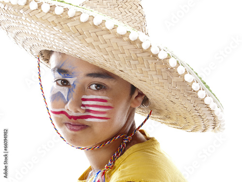 cute boy with fancy stars and stripes face paint wears a wide straw hat