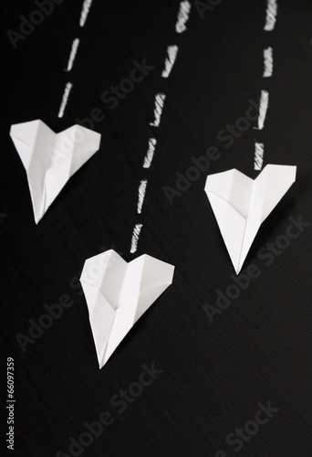 Fotografie Paper Planes fly in formation across a blackboard surface