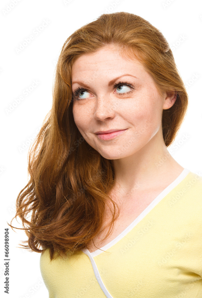 Young happy woman is looking up and smile