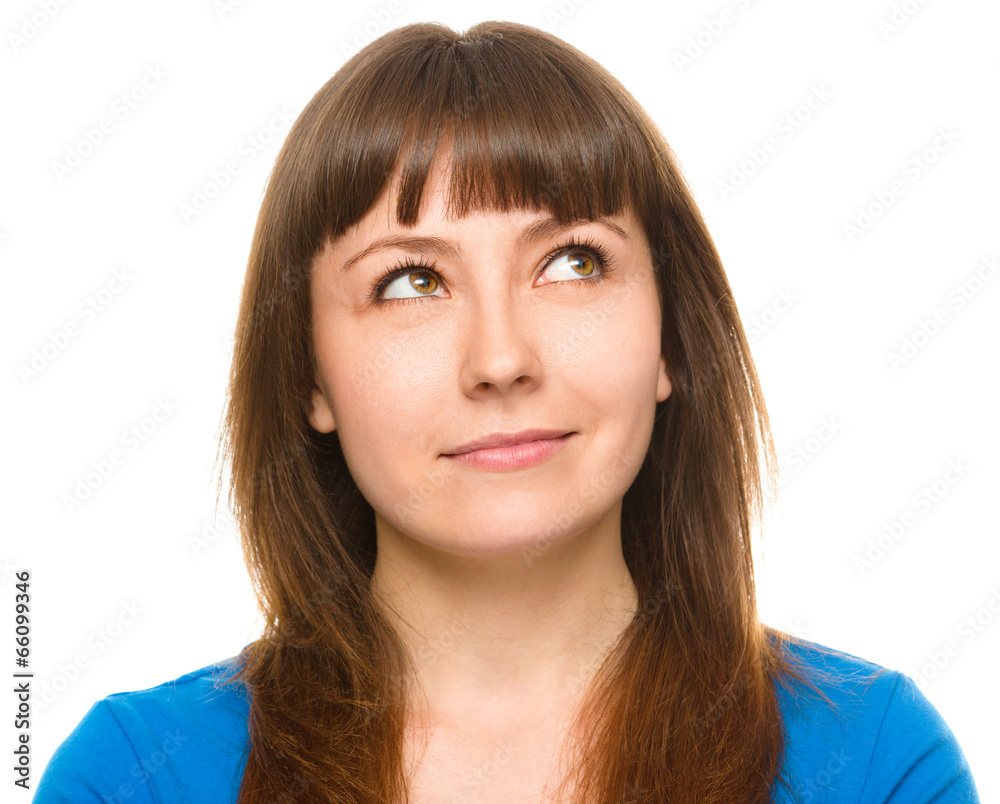 Young happy woman is looking up and smile Young happy woman is looking up and smile