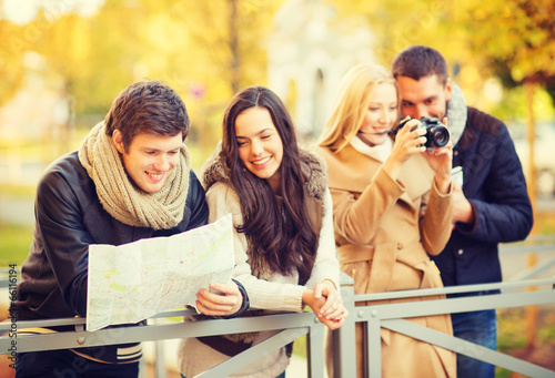 couples with tourist map and camera in autumn park