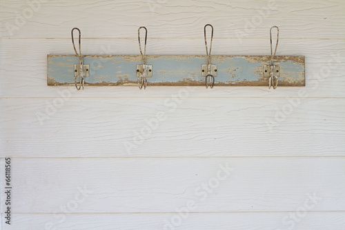 Rustic coat hooks background on white weatherboard house