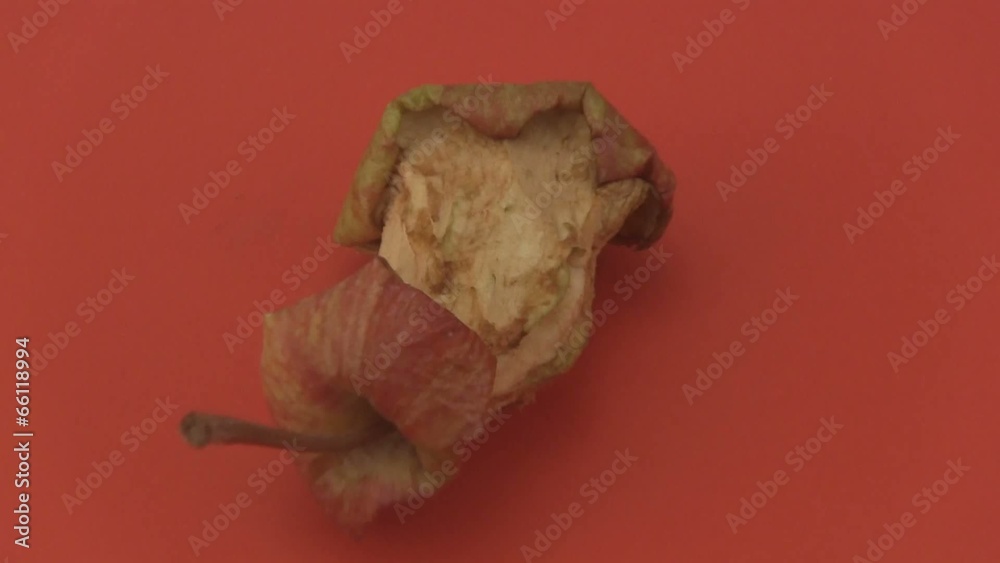 Apple core on a red background. Apple core on a red background.