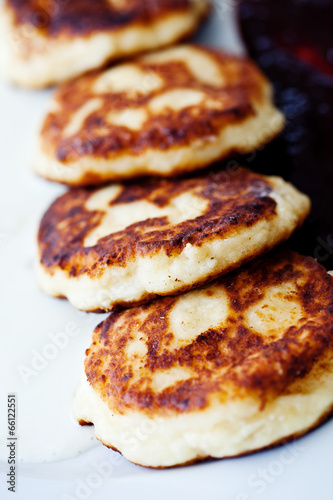 Cheese pancakes with sour cream and jam